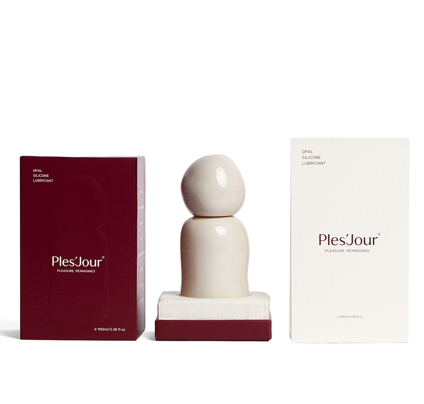 Ples’Jour Opal silicone lubricant in sculptural glass bottle displayed between boxes, showcasing luxury sexual wellness design.